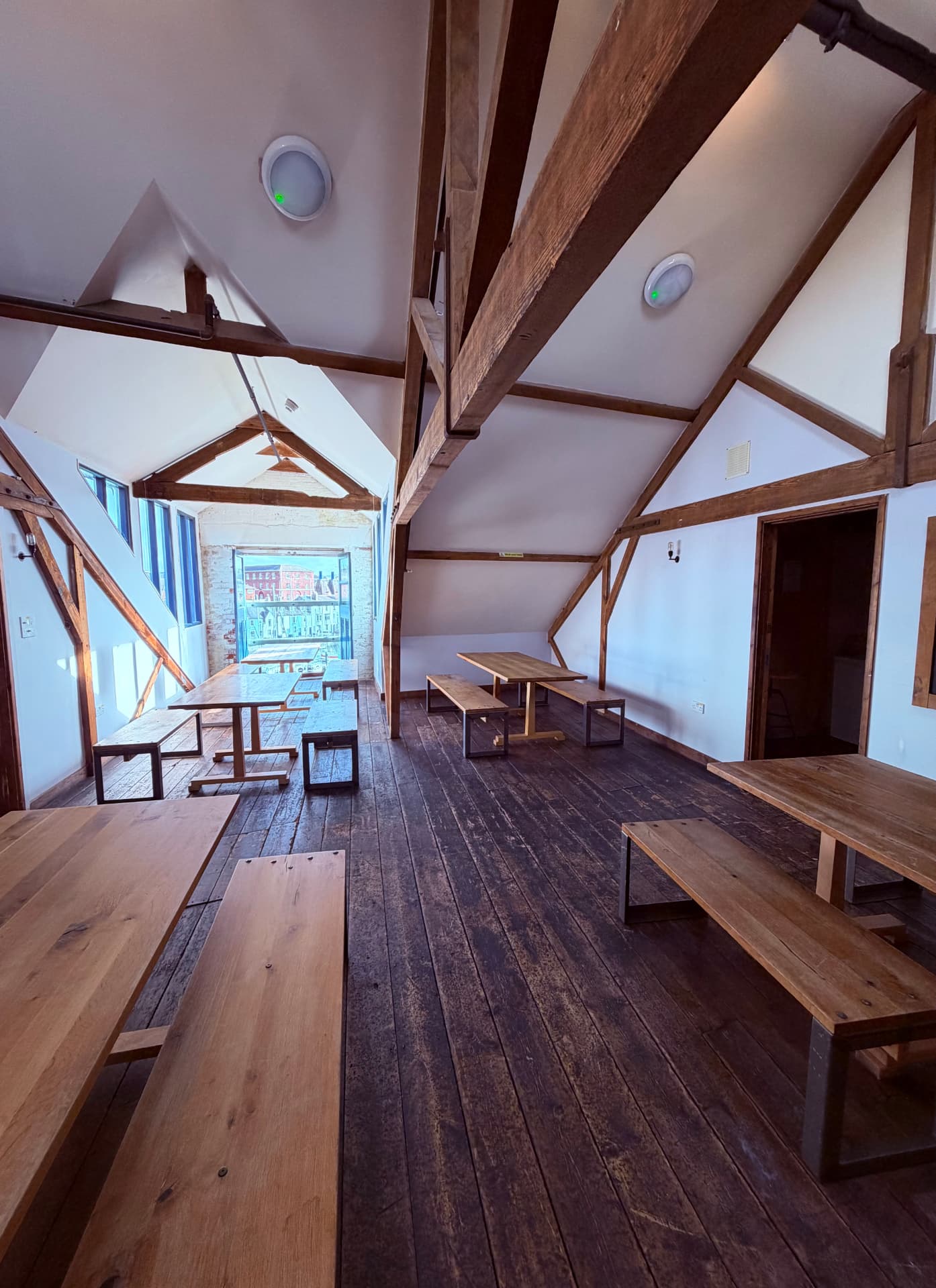 Wooden beam attic seating area on the third floor of Little Harbour Club overlooking Weymouth harbour